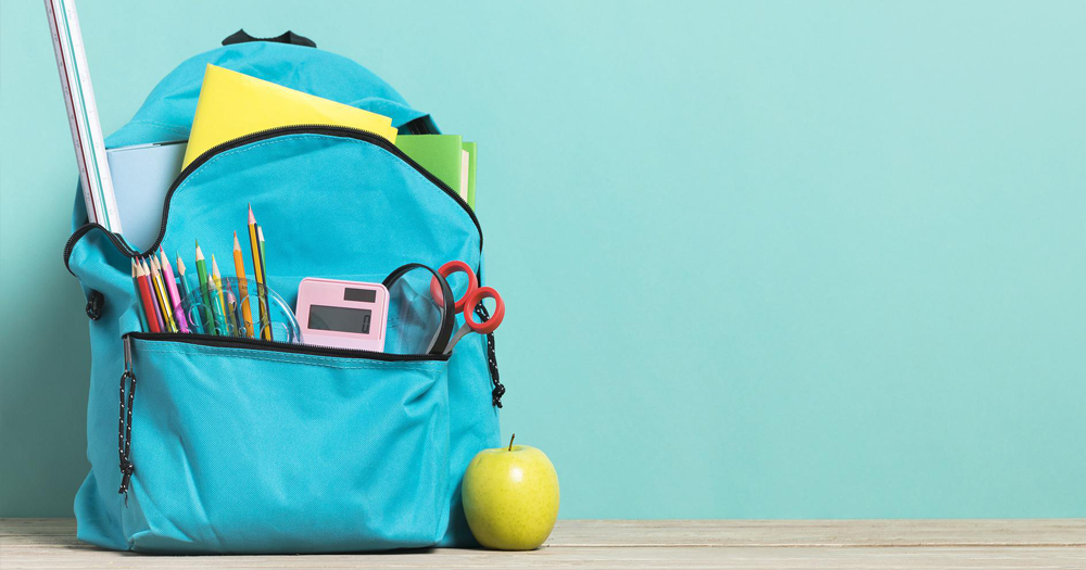 This story details my experience as a three-time college dropout. Pictured: a blue school bag with school supplies.