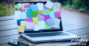 This blog is part of a series by mental health writer and Dear Blue Author, Saoirse Schad. Pictured: a laptop covered in sticky notes sitting on a picnic table outdoors