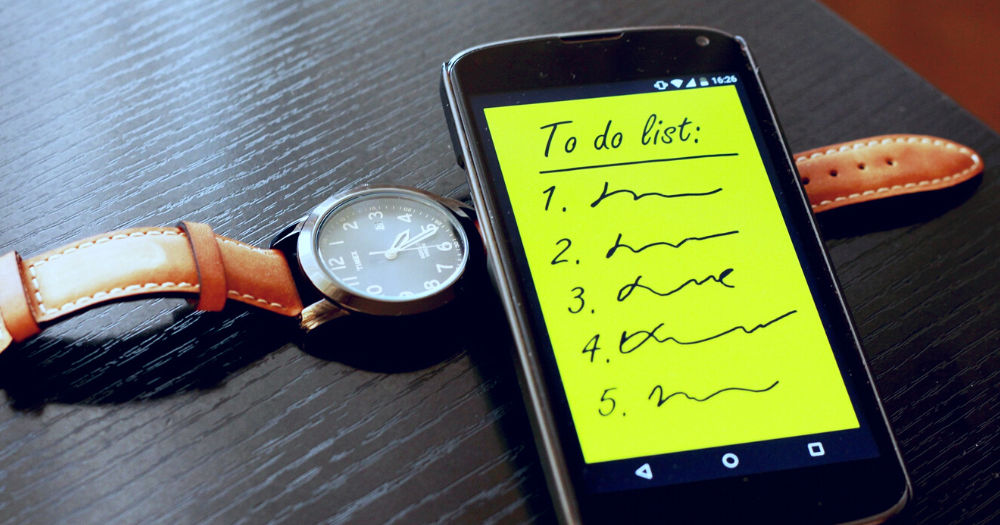 Pictured: a 'to do' list on a smart phone lying on a wrist-watch