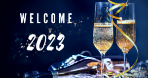 Pictured: two glasses of a sparkling drink, a glass bottle and the words 'welcome 2023'